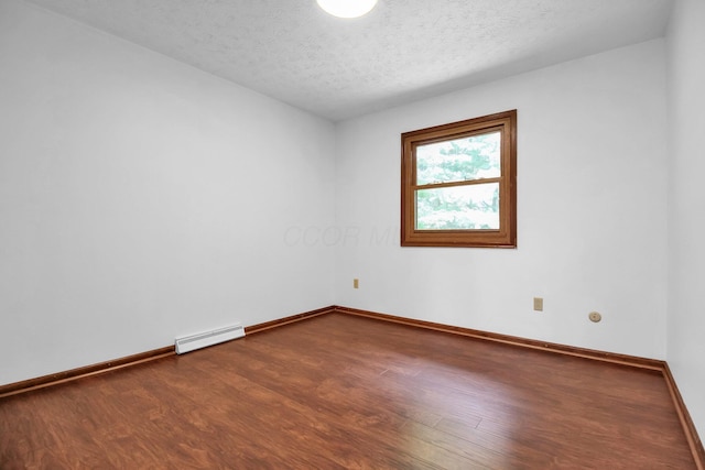 171 Ginder Rd NE, Lancaster, OH 43130 - spare room featuring a baseboard radiator, wood finished floors, and a textured ceiling