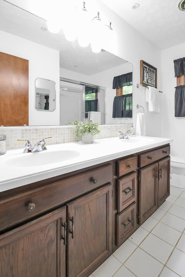 171 Ginder Rd NE, Lancaster, OH 43130 - bathroom featuring double vanity, tile patterned floors, and tasteful backsplash