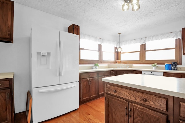 171 Ginder Rd NE, Lancaster, OH 43130 - kitchen with white appliances, light wood finished floors, light countertops, decorative light fixtures, and a textured ceiling