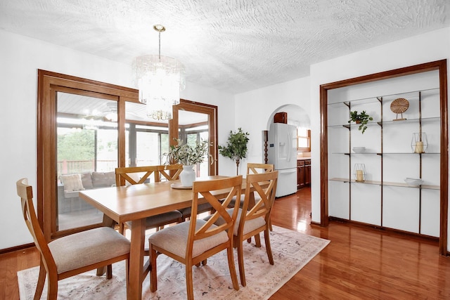 171 Ginder Rd NE, Lancaster, OH 43130 - dining area with wood finished floors, a chandelier, plenty of natural light, and a textured ceiling