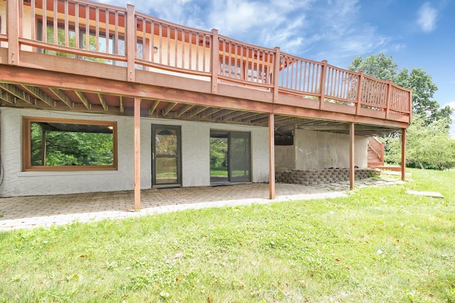 171 Ginder Rd NE, Lancaster, OH 43130 - rear view of property featuring a patio area, a lawn, a wooden deck, and stucco siding