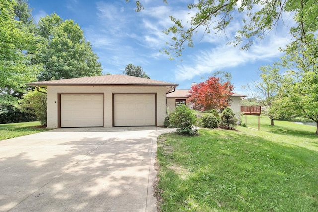 171 Ginder Rd NE, Lancaster, OH 43130 - view of front of home with a front yard, a garage, stucco siding, and concrete driveway