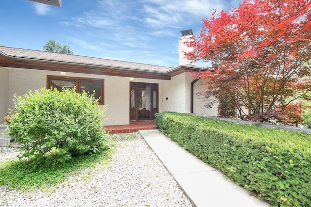 171 Ginder Rd NE, Lancaster, OH 43130 - doorway to property featuring stucco siding and a chimney