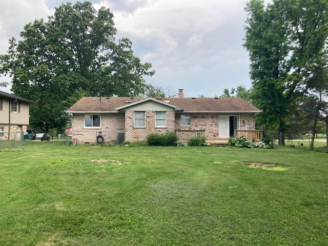 4173 Navajo Trl, Jamestown, OH 45335 - rear view of property featuring brick siding, a deck, and a chimney