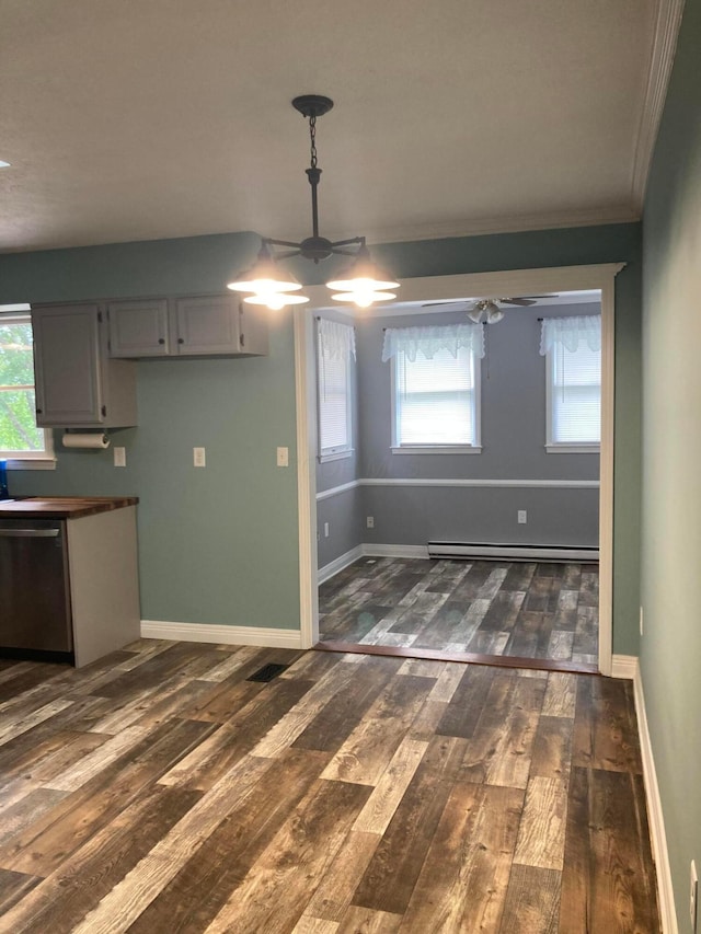 4173 Navajo Trl, Jamestown, OH 45335 - unfurnished dining area featuring a baseboard heating unit, ceiling fan, dark wood-type flooring, and ornamental molding