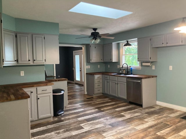 4173 Navajo Trl, Jamestown, OH 45335 - kitchen featuring stainless steel dishwasher, dark wood finished floors, butcher block countertops, and a skylight