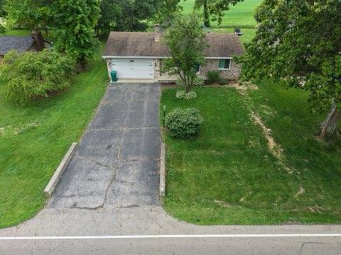 4173 Navajo Trl, Jamestown, OH 45335 - view of front of home with asphalt driveway, a front lawn, and a garage