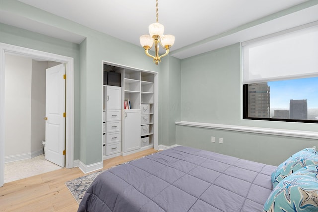 50 W Broad St Unit 3401, Columbus, OH 43215 - bedroom with light wood-style floors and a chandelier