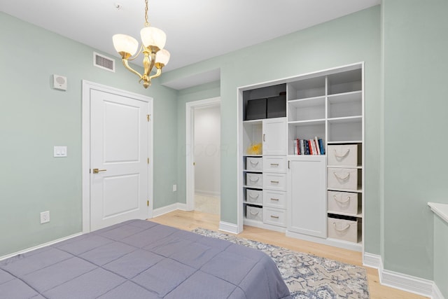 50 W Broad St Unit 3401, Columbus, OH 43215 - bedroom with a chandelier and light wood-style floors