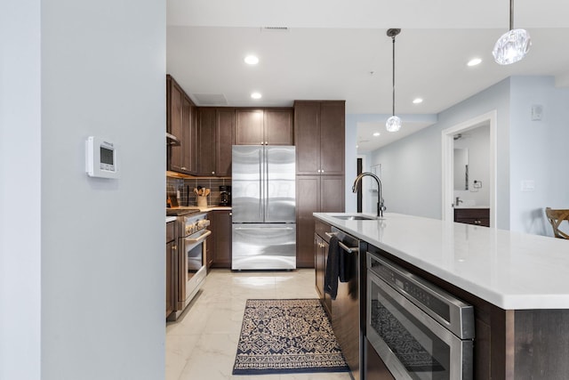 50 W Broad St Unit 3401, Columbus, OH 43215 - kitchen featuring premium appliances, light marble finish flooring, recessed lighting, decorative backsplash, and light countertops
