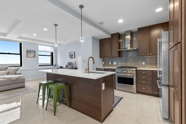 50 W Broad St Unit 3401, Columbus, OH 43215 - kitchen featuring appliances with stainless steel finishes, wall chimney range hood, open floor plan, light countertops, and light marble finish flooring