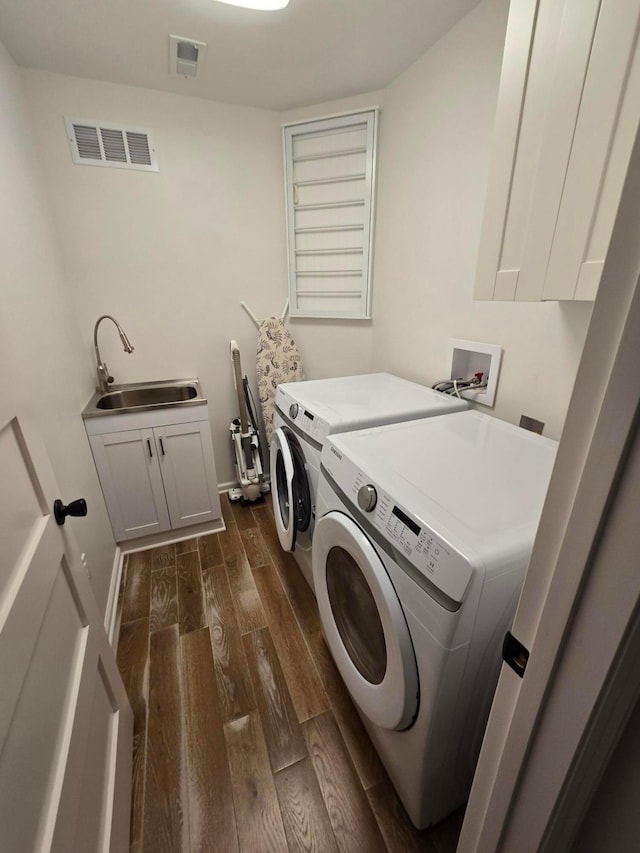 990 Venetian Way, Columbus, OH 43230 - washroom with washer and dryer, dark wood-type flooring, and cabinet space