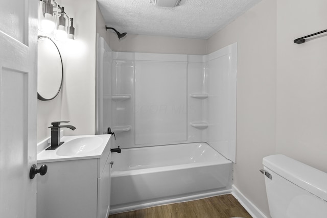 508 E Welch Ave, Columbus, OH 43207 - bathroom with a textured ceiling, wood finished floors, vanity, and shower / tub combination