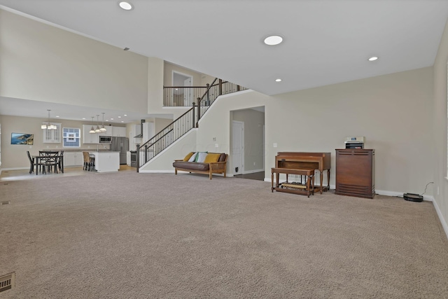 7263 Yarrow Run Rd, Plain City, OH 43064 - living area with stairway, light colored carpet, recessed lighting, a towering ceiling, and a chandelier