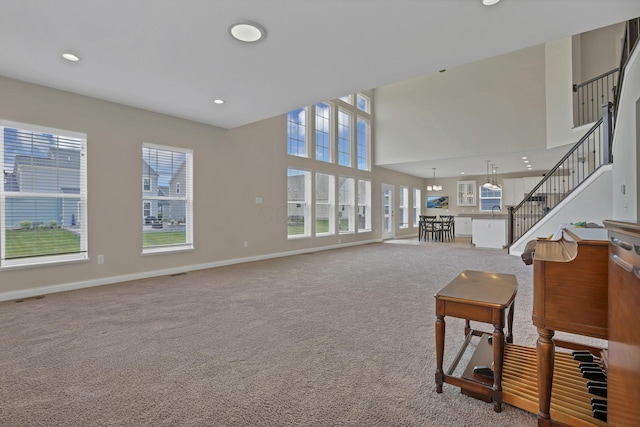 7263 Yarrow Run Rd, Plain City, OH 43064 - living area featuring healthy amount of natural light, carpet floors, stairway, recessed lighting, and a towering ceiling