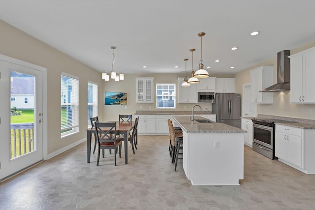 7263 Yarrow Run Rd, Plain City, OH 43064 - kitchen featuring wall chimney exhaust hood, stainless steel appliances, white cabinetry, recessed lighting, and an island with sink