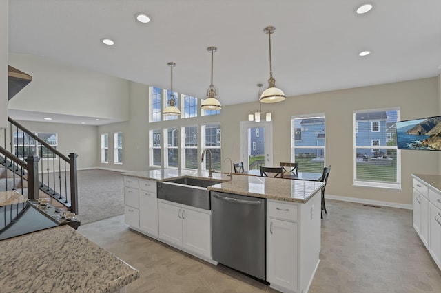 7263 Yarrow Run Rd, Plain City, OH 43064 - kitchen featuring stainless steel dishwasher, white cabinets, open floor plan, hanging light fixtures, and recessed lighting