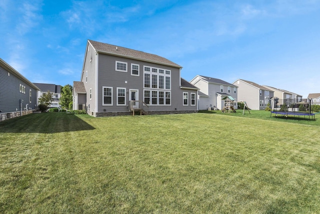 7263 Yarrow Run Rd, Plain City, OH 43064 - rear view of house featuring a trampoline, a playground, a residential view, and a yard