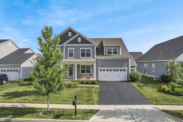 7263 Yarrow Run Rd, Plain City, OH 43064 - view of front facade featuring covered porch, driveway, a front lawn, a standing seam roof, and an attached garage