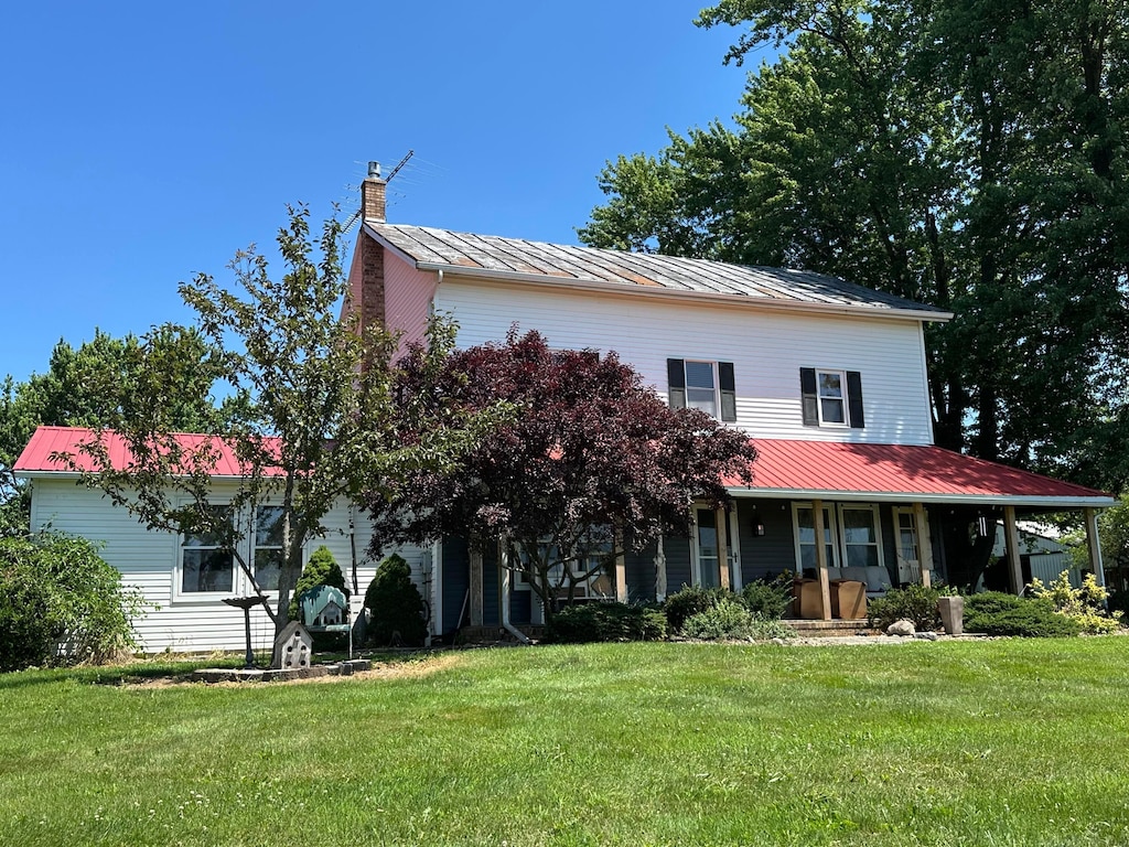 3140 Caldwell Rd, Bucyrus, OH 44820 - view of front of home with a metal roof, covered porch, a chimney, and a front lawn