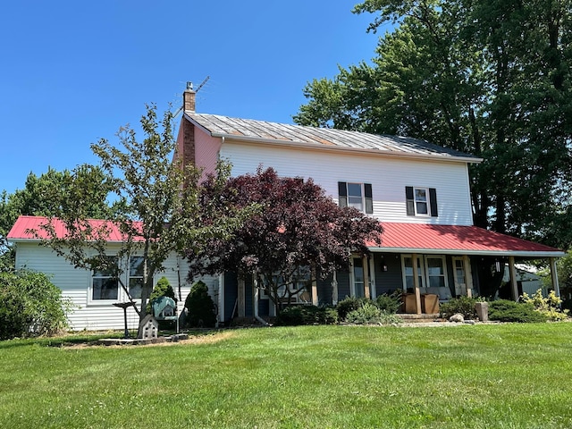 3140 Caldwell Rd, Bucyrus, OH 44820 - view of front of home with a metal roof, covered porch, a chimney, and a front lawn