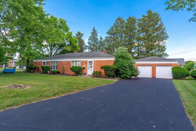 3016 Welsford Rd, Columbus, OH 43221 - view of front of property with a front yard, a chimney, brick siding, and a detached garage