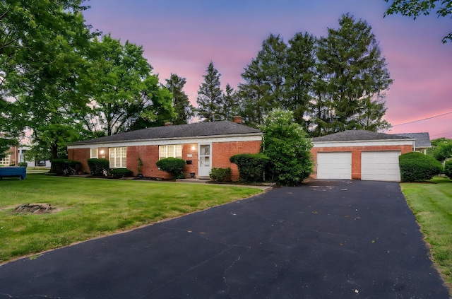 3016 Welsford Rd, Columbus, OH 43221 - view of front of house with brick siding, a yard, a chimney, and a garage