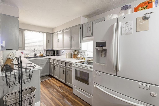9020 Kinney Rd, Mount Vernon, OH 43050 - kitchen with white appliances, gray cabinets, dark wood-style floors, and plenty of natural light