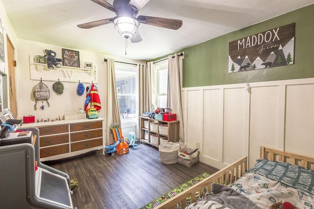 9020 Kinney Rd, Mount Vernon, OH 43050 - bedroom with dark wood finished floors, a decorative wall, wainscoting, and ceiling fan