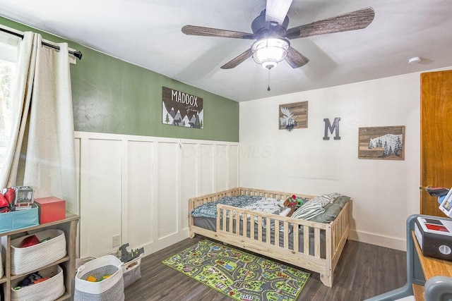 9020 Kinney Rd, Mount Vernon, OH 43050 - bedroom featuring wood finished floors, wainscoting, ceiling fan, and a decorative wall