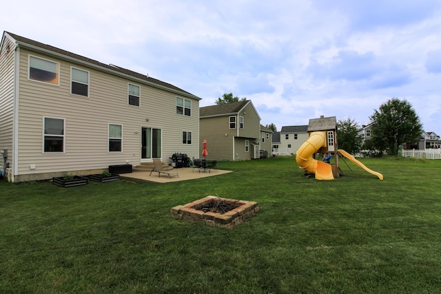 9065 Strawser St, Orient, OH 43146 - rear view of house featuring an outdoor fire pit, a patio, a playground, and a lawn