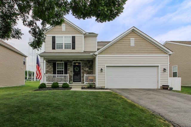 9065 Strawser St, Orient, OH 43146 - view of front of property with driveway, covered porch, an attached garage, a front yard, and stone siding