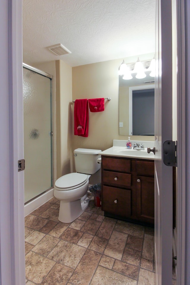 9065 Strawser St, Orient, OH 43146 - bathroom featuring vanity, a shower stall, stone finish floors, and a textured ceiling