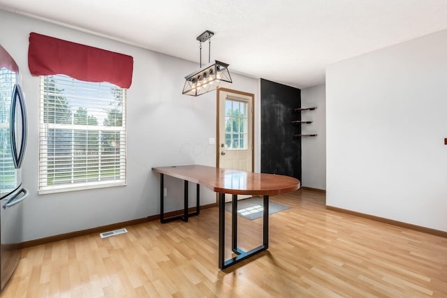 277 Plum Run Ct, Commercial Point, OH 43116 - unfurnished dining area featuring light wood finished floors and baseboards