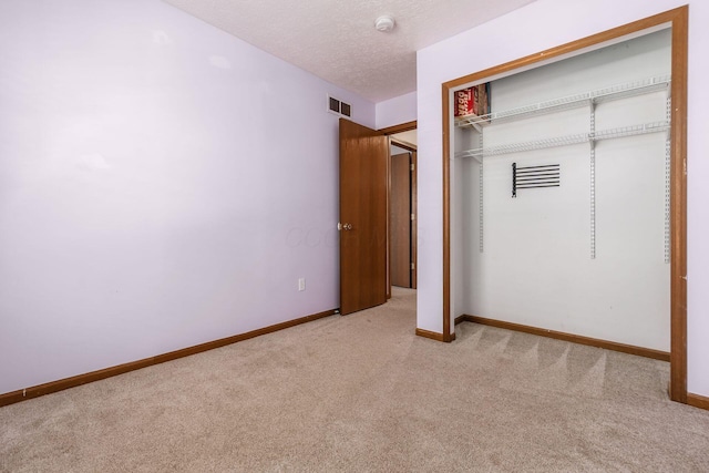 277 Plum Run Ct, Commercial Point, OH 43116 - unfurnished bedroom with light carpet, a closet, and a textured ceiling