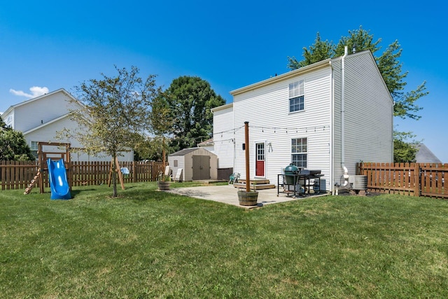 277 Plum Run Ct, Commercial Point, OH 43116 - rear view of house with a storage shed, a patio, a fenced backyard, and a playground