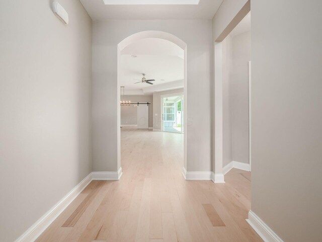 3311 Polden Hill Dr Unit 24, New Albany, OH 43054 - hallway with arched walkways and light wood-style floors