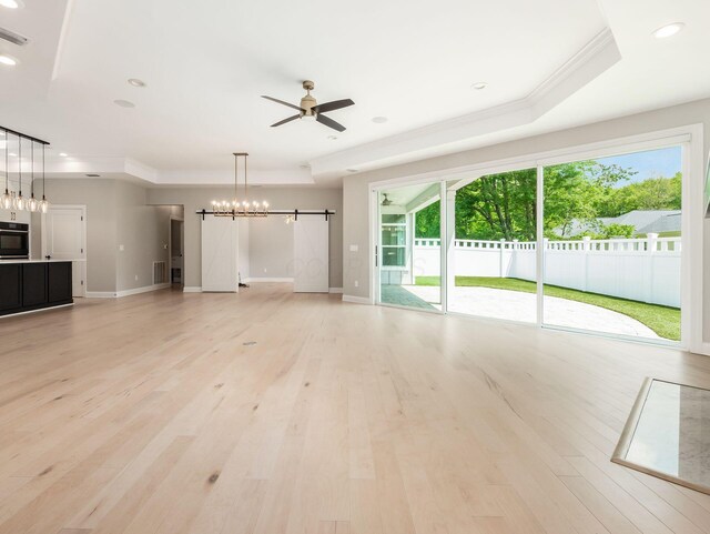 3311 Polden Hill Dr Unit 24, New Albany, OH 43054 - unfurnished living room featuring crown molding, ceiling fan, light wood-style flooring, recessed lighting, and a raised ceiling