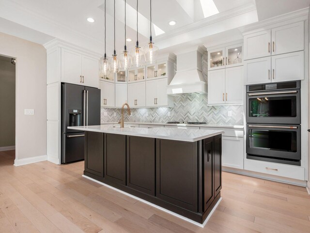 3311 Polden Hill Dr Unit 24, New Albany, OH 43054 - kitchen with double oven, high quality fridge, custom exhaust hood, light countertops, and white cabinetry