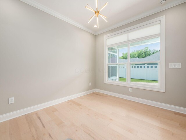 3311 Polden Hill Dr Unit 24, New Albany, OH 43054 - spare room with crown molding, a chandelier, light wood-style floors, and a smoke detector