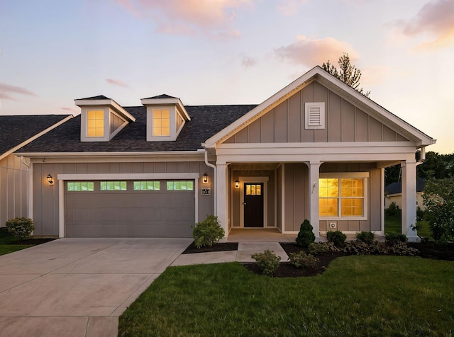 3311 Polden Hill Dr Unit 24, New Albany, OH 43054 - view of front of house with board and batten siding, a shingled roof, a garage, a front lawn, and concrete driveway
