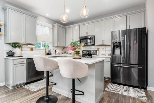 7036 Cannon Dr, Canal Winchester, OH 43110 - kitchen with stainless steel appliances, dark wood finished floors, light countertops, backsplash, and recessed lighting