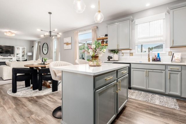 7036 Cannon Dr, Canal Winchester, OH 43110 - kitchen with gray cabinetry, open floor plan, plenty of natural light, light countertops, and recessed lighting