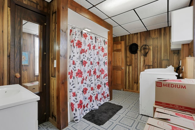 16703 Watkins Rd, Haydenville, OH 43127 - full bath featuring wood walls, washer / dryer, a shower with shower curtain, tile patterned floors, and vanity