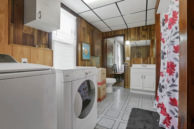16703 Watkins Rd, Haydenville, OH 43127 - washroom featuring wood walls, light floors, and separate washer and dryer