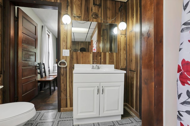 16703 Watkins Rd, Haydenville, OH 43127 - bathroom with wooden walls, vanity, and tile patterned flooring