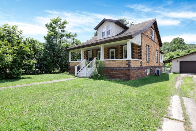 16703 Watkins Rd, Haydenville, OH 43127 - bungalow featuring covered porch, a front yard, an outbuilding, and a garage
