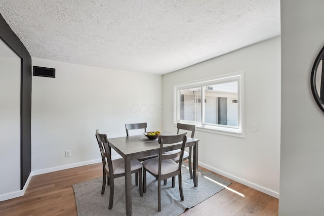 1366 Brown Rd, Columbus, OH 43223 - dining space with wood finished floors and a textured ceiling