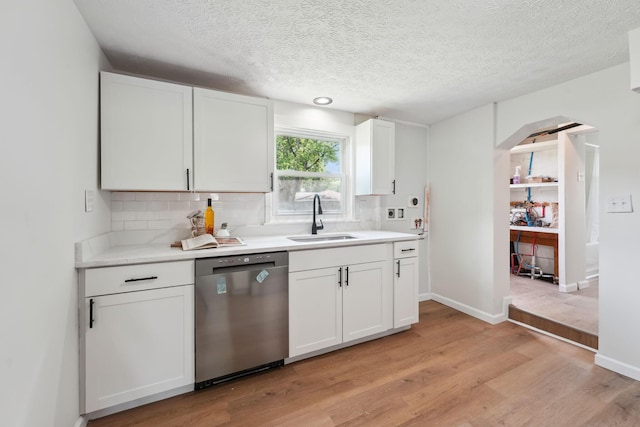 1366 Brown Rd, Columbus, OH 43223 - kitchen featuring dishwasher, backsplash, light wood finished floors, white cabinets, and light countertops