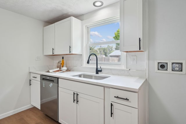 1366 Brown Rd, Columbus, OH 43223 - kitchen with dishwasher, tasteful backsplash, wood finished floors, white cabinets, and light countertops